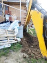 The excavator digging a trench near a cable house for a small bucket Royalty Free Stock Photo