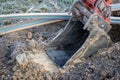 Excavator digging a trench to lay a high-speed Internet DSL cable