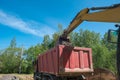 excavator digs clay soil at the construction site