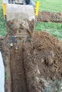 The excavator digs a small trench in the yard Royalty Free Stock Photo