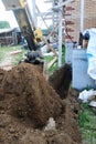 The excavator digs a small trench in the yard