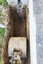 The excavator digs a small trench in the yard