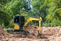 The excavator digs a soil. Digger loading trucks with soil. Excavator working on earthmoving at open pit mining. Excavator working