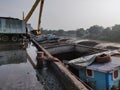 Excavator discharge coal to truck at jetty