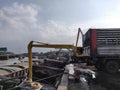 Excavator discharge coal to truck at jetty