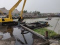 Excavator discharge coal to truck at jetty