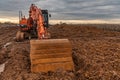 Excavator doing work on a wet and muddy winter day