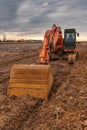 Excavator doing work on a wet and muddy winter day