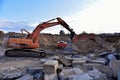 Excavator DOOSAN with hydraulic breaker hammer for the destruction of concrete and hard rock at the open
