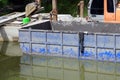 A excavator dredging with a barge was working in the canal