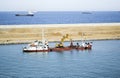 Excavator dredging on ship