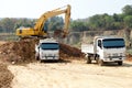 Excavator and dump truck tipper in construction site Royalty Free Stock Photo