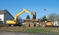 Excavator Dumping Soil into Dump Truck Royalty Free Stock Photo