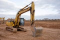 Excavator during earthmoving at construction site. Backhoe dig ground for the construction of foundation and laying sewer pipes Royalty Free Stock Photo