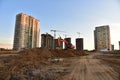 Excavator on earthmoving at construction site. Road work and Dig pit foundation. Tower cranes in action on sunset background. Royalty Free Stock Photo