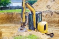 Excavator during earthmoving work at foundation pit for construction of underground Royalty Free Stock Photo