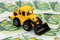 Excavator on euro banknotes Royalty Free Stock Photo