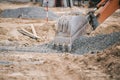 An excavator in front of a pile of rubble during an urban redevelopment