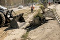 Excavator, grader and workers remove debris after dismantling a tram stop. Works on tram tracks