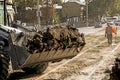 Excavator, grader and workers remove debris after dismantling a tram stop. Works on tram tracks