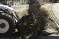 Excavator, grader and workers remove debris after dismantling a tram stop. Works on tram tracks