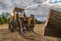 Excavator with grapple for transporting logs in a forestry operation