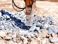 Excavator with hammer demolishes