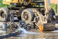Excavator helps to eliminate the problem of breaking a pipe in the street on a hot summer day