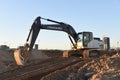 Excavator Hidromek HMK 220 LC working at construction site. Construction machinery for excavation, loading, lifting and hauling of