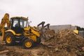 Excavator at house construction site - digging foundations for modern house Royalty Free Stock Photo