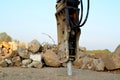 Excavator with hydraulic breaker hammer for the destruction of concrete and hard rock at the construction site or quarry. Royalty Free Stock Photo