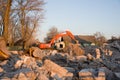 Excavator with hydraulic breaker hammer for the destruction of concrete and hard rock at the construction site. Royalty Free Stock Photo