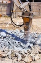 Excavator with hydraulic hammer breaking concrete Royalty Free Stock Photo