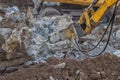 Excavator with hydraulic hammer breaking concrete 3