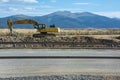 Excavator with hydraulic hammer on road construction works Royalty Free Stock Photo