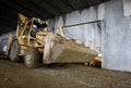 Excavator inside industrial building in progress