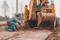 The excavator installs concrete slabs for the road Royalty Free Stock Photo