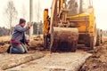 The excavator installs concrete slabs for the road Royalty Free Stock Photo