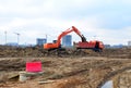 Excavator load the sand to the heavy dump truck on construction site.