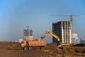 Excavator load the sand to the heavy dump truck on construction site. Excavators and dozers digs the ground for the foundation