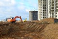 Excavator load the sand to the heavy dump truck on construction site. Excavators and dozers digs the ground for the foundation