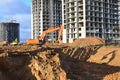 Excavator load the sand to the heavy dump truck on construction site. Excavators and dozers digs the ground for the foundation