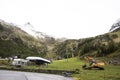 Excavator loader or backhoe machinery waiting works outdoors at otztal alps Royalty Free Stock Photo