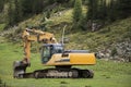 Excavator loader or backhoe machinery waiting works outdoors at otztal alps Royalty Free Stock Photo