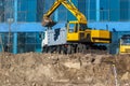 Excavator loader and dump truck during earthworks at a construction site. Loading land in the back of a heavy truck. Royalty Free Stock Photo