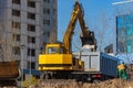 Excavator loader and dump truck during earthworks at a construction site. Loading land in the back of a heavy truck. Royalty Free Stock Photo