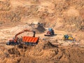 Excavator loader machine loading dumper truck at construction site. digger and wheel loader heavy duty construction Royalty Free Stock Photo