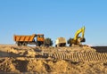 Excavator loader with rised backhoe in a sky background Royalty Free Stock Photo