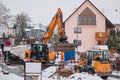 Excavator and Loader Working Together at Winter Road Construction Royalty Free Stock Photo