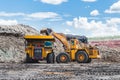 Excavator loading of coal, ore on the dump truck. The big dump t Royalty Free Stock Photo